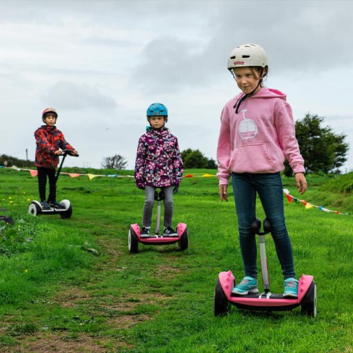 Young participants on pink Segways at Hendra location with Cornwall Segway