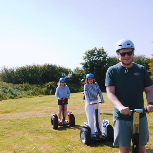 Group riding X2 Segways through course with smiles at Cornwall Segway